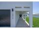 Modern entryway with covered walkway, leading to the front door at 16015 Redington Dr, Redington Beach, FL 33708