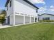 Contemporary home exterior with a spacious yard and covered parking at 16015 Redington Dr, Redington Beach, FL 33708