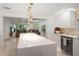 Modern kitchen with island and view into living room at 16015 Redington Dr, Redington Beach, FL 33708