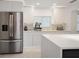 Stainless steel refrigerator in modern white kitchen at 16015 Redington Dr, Redington Beach, FL 33708