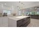 Modern kitchen island with white cabinets and quartz countertops at 16015 Redington Dr, Redington Beach, FL 33708