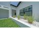 Landscaped planter with ornamental grasses next to the house at 16015 Redington Dr, Redington Beach, FL 33708