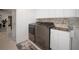 Modern laundry room with stainless steel appliances and white cabinets at 16015 Redington Dr, Redington Beach, FL 33708