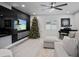 Spacious living room with a modern media wall and Christmas tree at 16015 Redington Dr, Redington Beach, FL 33708