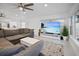 Living room with sectional sofa and large TV at 16015 Redington Dr, Redington Beach, FL 33708