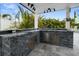 Outdoor kitchen with granite countertops and stainless steel appliances at 16015 Redington Dr, Redington Beach, FL 33708