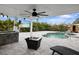 Outdoor kitchen with granite countertops and fire pit at 16015 Redington Dr, Redington Beach, FL 33708