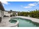 Inviting pool and spa area with outdoor kitchen and covered patio at 16015 Redington Dr, Redington Beach, FL 33708