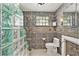 Bathroom with glass block shower and tiled walls at 17602 Sterling Ter, Redington Shores, FL 33708