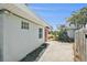 House exterior with a red door and side yard at 17602 Sterling Ter, Redington Shores, FL 33708