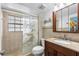 Clean bathroom with shower, granite vanity, and decorative accents at 17980 Gulf Blvd # 501, Redington Shores, FL 33708