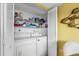 Bright laundry closet with washer, dryer, and shelving at 17980 Gulf Blvd # 501, Redington Shores, FL 33708