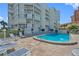 Inviting resort-style pool with lounge chairs and surrounding patio at 17980 Gulf Blvd # 501, Redington Shores, FL 33708