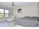 Bright bedroom with a comfy chair and large bed at 19029 Us Highway 19 N # 6-16, Clearwater, FL 33764