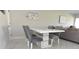 Modern dining area with gray chairs and white table at 19029 Us Highway 19 N # 6-16, Clearwater, FL 33764