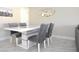 Modern dining area with gray chairs and white table at 19029 Us Highway 19 N # 6-16, Clearwater, FL 33764