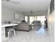 Spacious living room with gray sectional sofa and access to balcony at 19029 Us Highway 19 N # 6-16, Clearwater, FL 33764