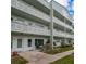 Two-story building exterior, featuring multiple units with balconies and landscaping at 2256 Philippine Dr # 18, Clearwater, FL 33763