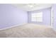 Large bedroom with light purple walls and carpeted floor at 2547 Lexington Oak Dr, Brandon, FL 33511