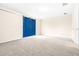 Spacious bedroom with blue barn door and neutral carpeting at 2547 Lexington Oak Dr, Brandon, FL 33511