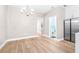 Bright dining area with hardwood floors and modern chandelier at 2547 Lexington Oak Dr, Brandon, FL 33511