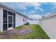 Fenced backyard with grassy area and screened enclosure at 2564 89Th Street E Cir, Palmetto, FL 34221