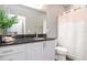 Modern bathroom with white cabinets, dark countertop, and white shower curtain at 2564 89Th Street E Cir, Palmetto, FL 34221