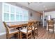 Bright dining area features a wood table with seating for six and large windows with plantation shutters at 2564 89Th Street E Cir, Palmetto, FL 34221