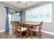 Dining area with wood table, chairs, and plantation shutters at 2564 89Th Street E Cir, Palmetto, FL 34221