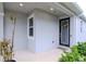 Front entry with black door and sidelights, welcoming porch at 2564 89Th Street E Cir, Palmetto, FL 34221