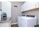 Laundry room with washer, dryer, and white cabinets at 2564 89Th Street E Cir, Palmetto, FL 34221