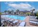 Community pool with lounge chairs and surrounding building at 2564 89Th Street E Cir, Palmetto, FL 34221