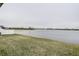 Lake view from backyard with grassy area and white fence at 2667 89Th Street E Cir, Palmetto, FL 34221