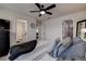 Spacious bedroom with gray bedding, ceiling fan, and ensuite bathroom at 2667 89Th Street E Cir, Palmetto, FL 34221