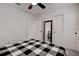 Bedroom with black and white bedding and ceiling fan at 2667 89Th Street E Cir, Palmetto, FL 34221