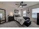 Bright bedroom with a queen-size bed, gray carpet, and ceiling fan at 2667 89Th Street E Cir, Palmetto, FL 34221