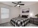 Bedroom with black and white bedding and ceiling fan at 2667 89Th Street E Cir, Palmetto, FL 34221