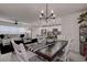 Open concept dining room with dark wood table and view into the living room at 2667 89Th Street E Cir, Palmetto, FL 34221