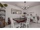 Farmhouse style dining room with a dark wood table and white chairs at 2667 89Th Street E Cir, Palmetto, FL 34221