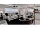 Living room with gray sectional sofa, white coffee table, and black accent chairs at 2667 89Th Street E Cir, Palmetto, FL 34221