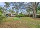 Large backyard with lush landscaping and a lounge chair at 2819 50Th S St, Gulfport, FL 33707