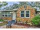 Charming stone cottage with a green exterior and landscaped front yard at 2819 50Th S St, Gulfport, FL 33707