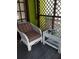 Relaxing white wicker chair and side table on a screened porch at 2819 50Th S St, Gulfport, FL 33707