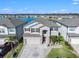 Aerial view of two-story house with brick facade and landscaping at 3071 Marine Grass Dr, Wimauma, FL 33598