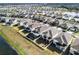 Aerial view of houses with screened-in pools and fenced yards at 3071 Marine Grass Dr, Wimauma, FL 33598