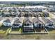 Aerial view of houses with screened-in pools and fenced yards at 3071 Marine Grass Dr, Wimauma, FL 33598