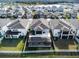 Aerial view of houses with screened-in pools and fenced yards at 3071 Marine Grass Dr, Wimauma, FL 33598