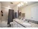 Bathroom with double vanity, granite countertop, and a bathtub at 3071 Marine Grass Dr, Wimauma, FL 33598