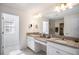 Double vanity bathroom with granite countertops at 3071 Marine Grass Dr, Wimauma, FL 33598