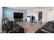 Large bonus room with two sofas and a TV at 3071 Marine Grass Dr, Wimauma, FL 33598